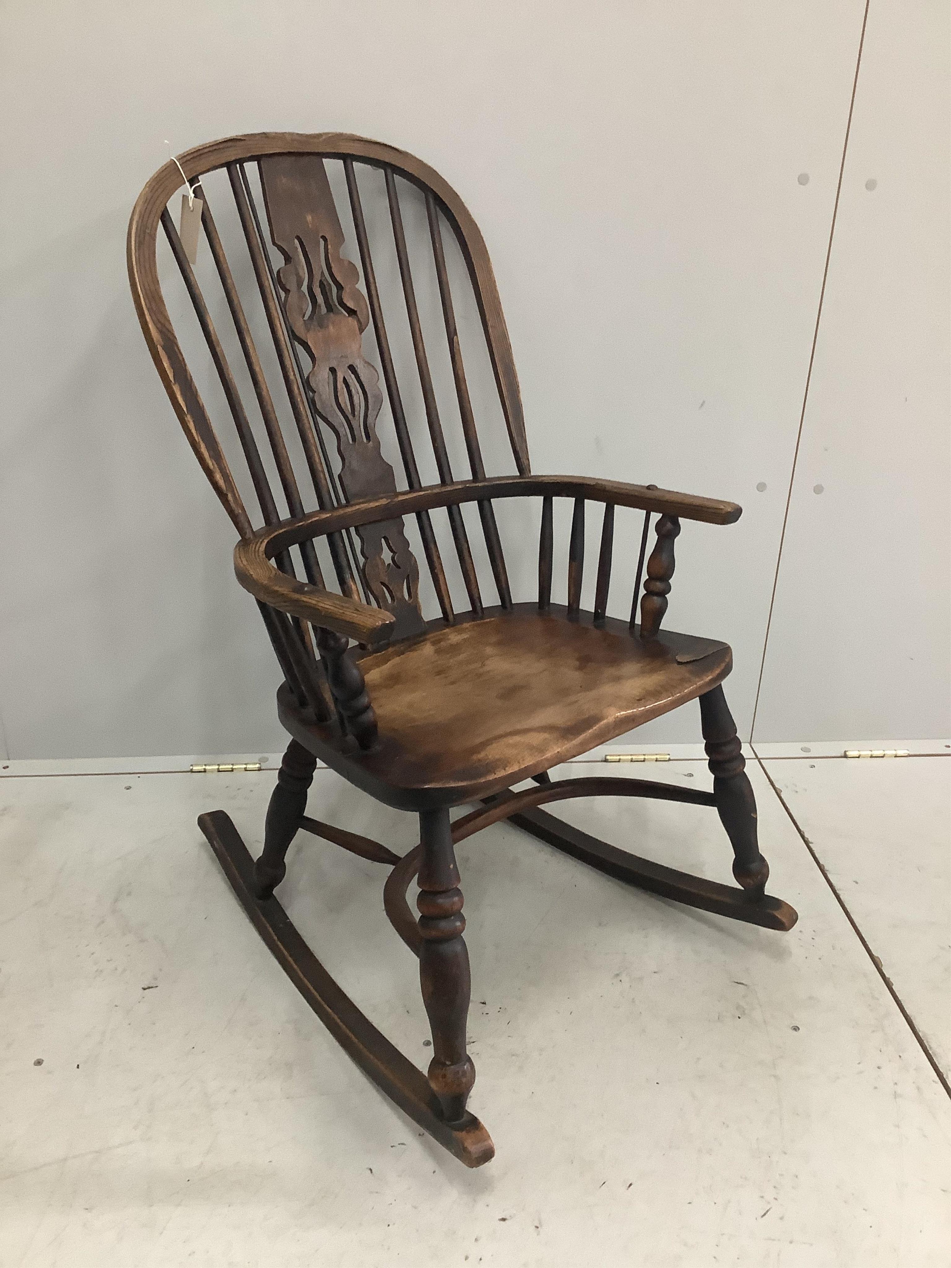 A 19th century ash, elm and beech Windsor rocking chair, width 53cm, depth 38cm, height 96cm. Condition - poor